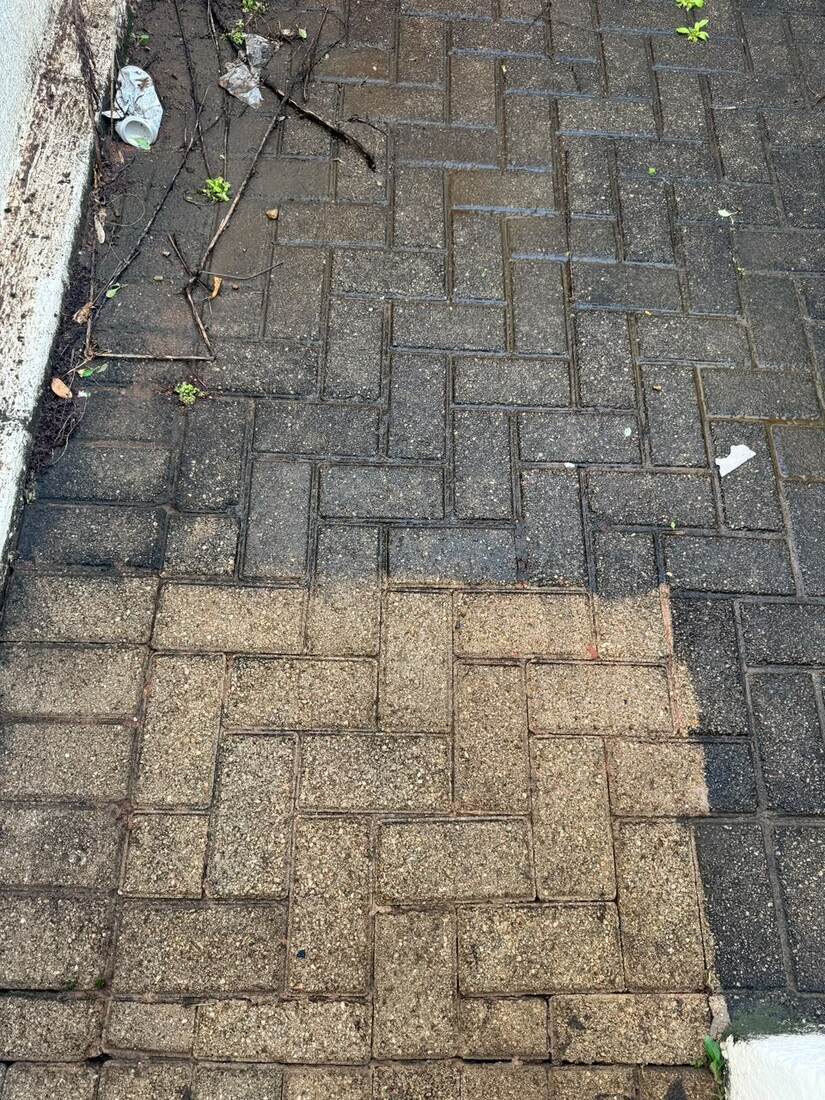 Paving cleaning in progress showing partial restoration
